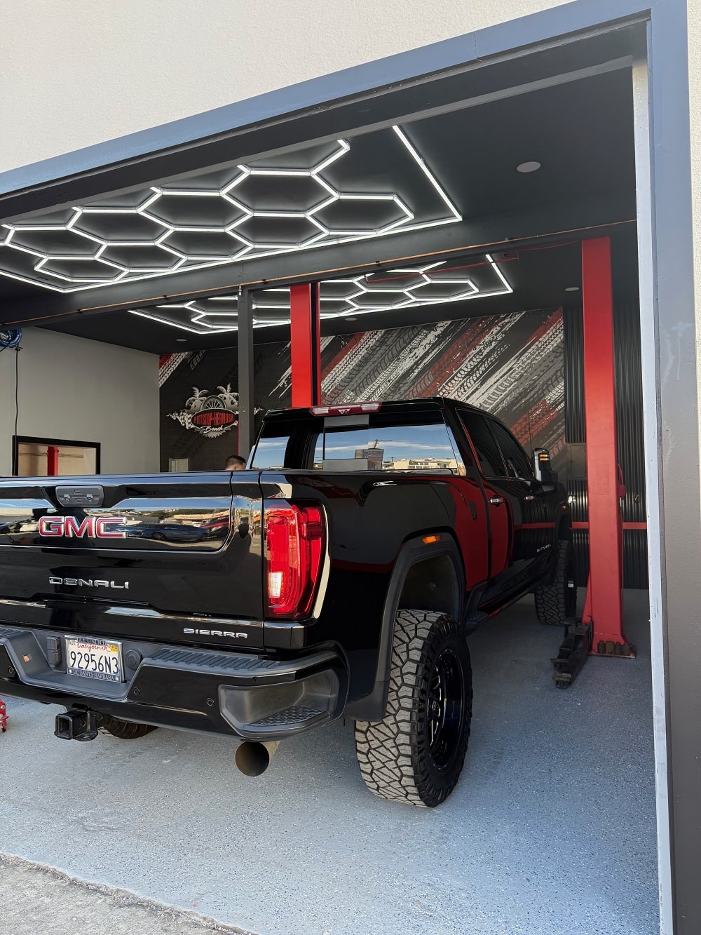 A GMC parked at an auto repair shop, awaiting car maintenance
