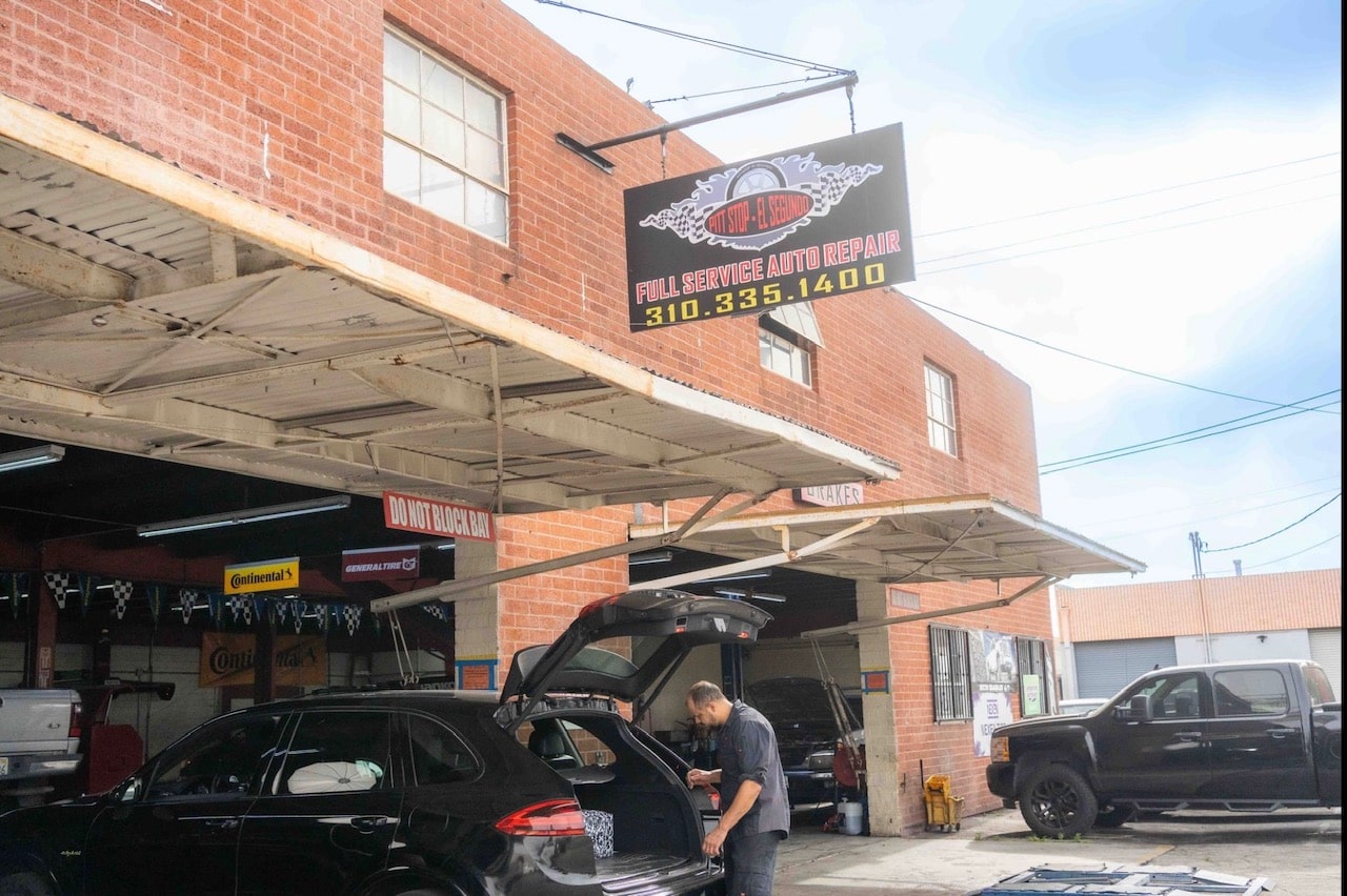 A mechanic performing car detailing services at Pitt Stop Auto
