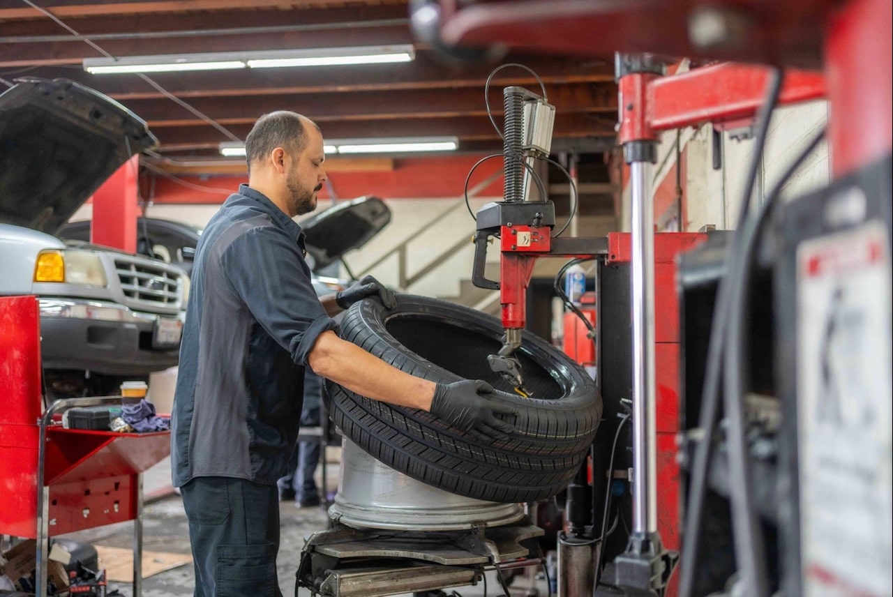 Expert mechanic fixing a punctured tire