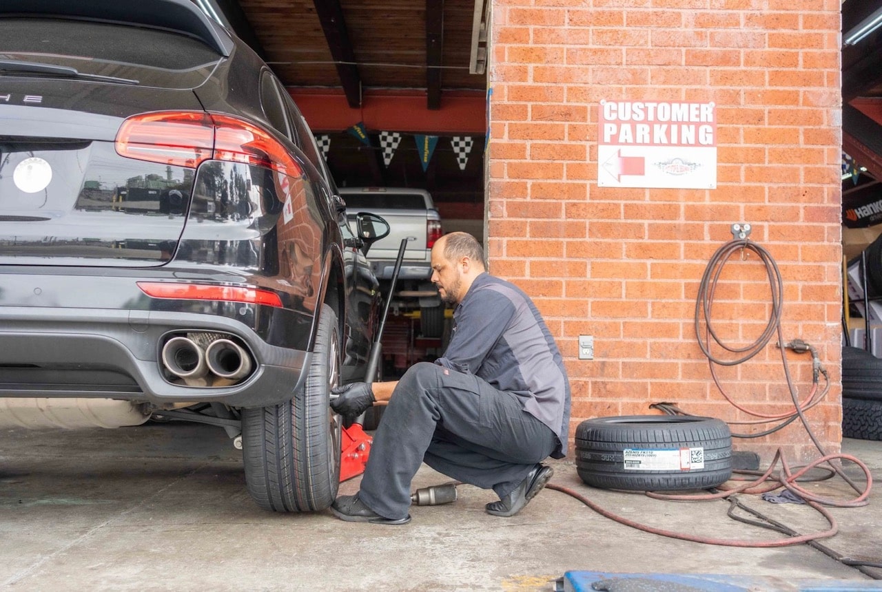 Mechanic adjusting the tire's air pressure